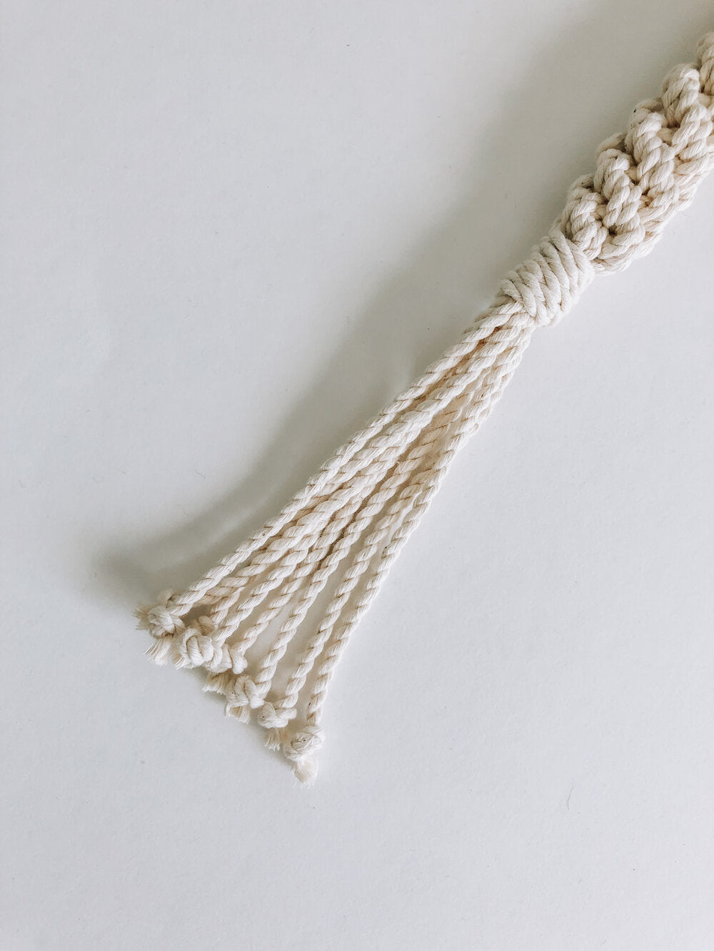 Handmade macrame dog toy in natural closeup of bottom