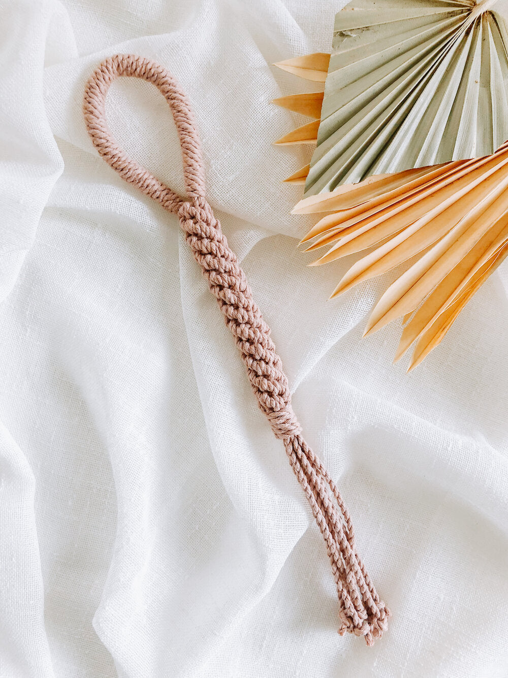 Handmade macrame dog toy in blush