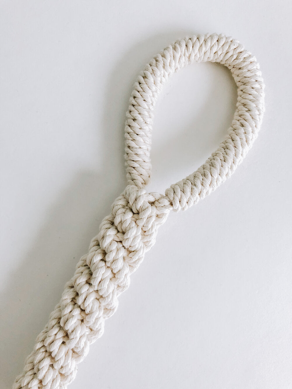 Handmade macrame dog toy in natural closeup
